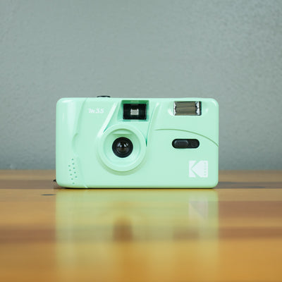 A front view of a mint-colored Kodak M35 Film Camera.