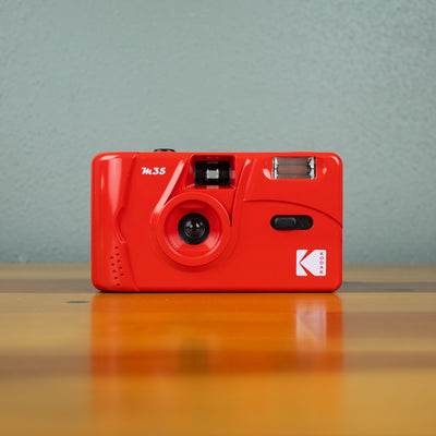 A front view of a red-colored Kodak M35 Film Camera.